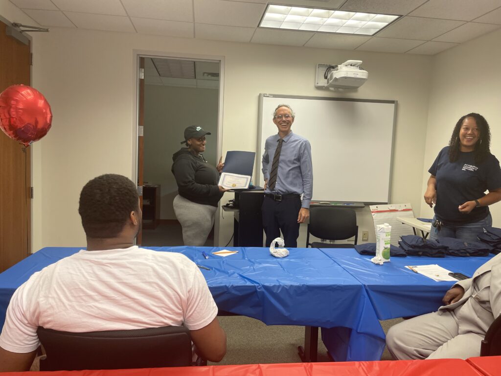 A Pr.E.P school graduate receiving a diploma