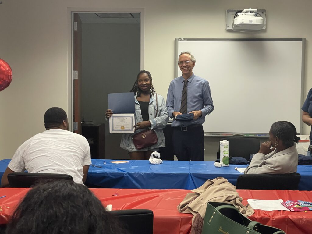 A Pr.E.P school graduate receiving a diploma