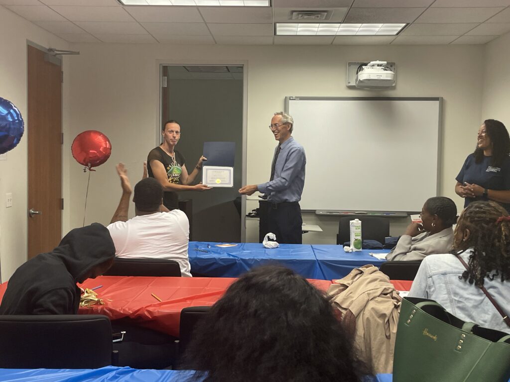 A Pr.E.P school graduate receiving a diploma