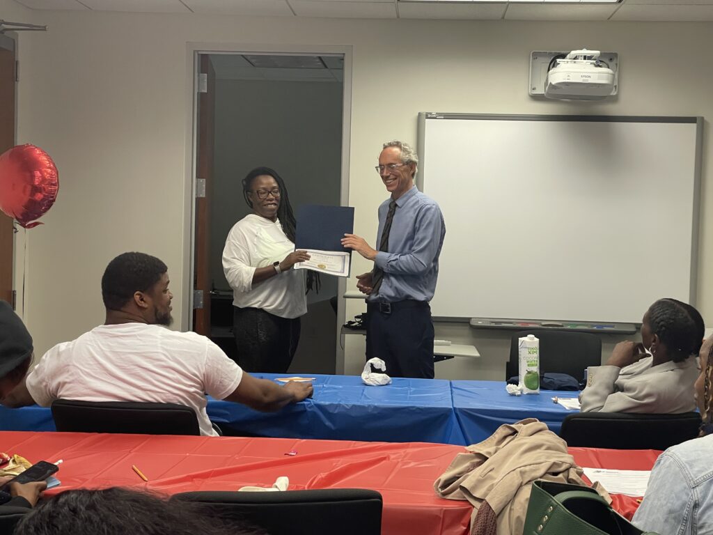 A Pr.E.P school graduate receiving a diploma