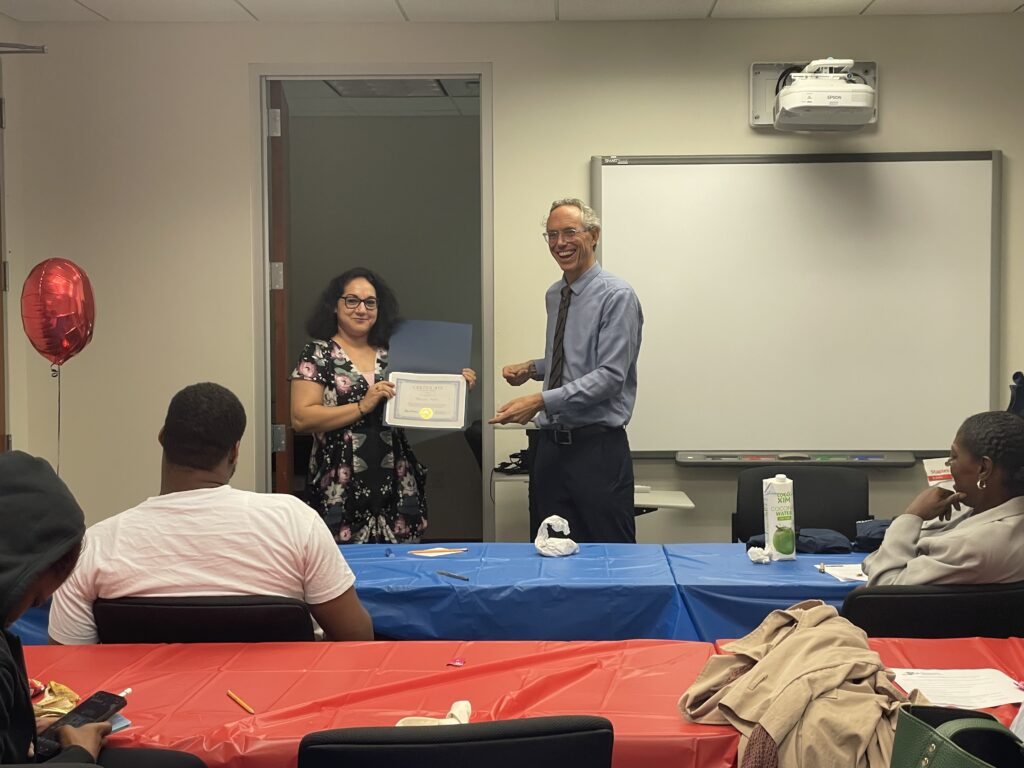 A Pr.E.P school graduate receiving a diploma