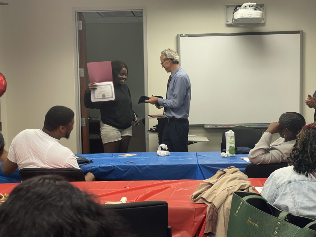 A Pr.E.P school graduate receiving a diploma