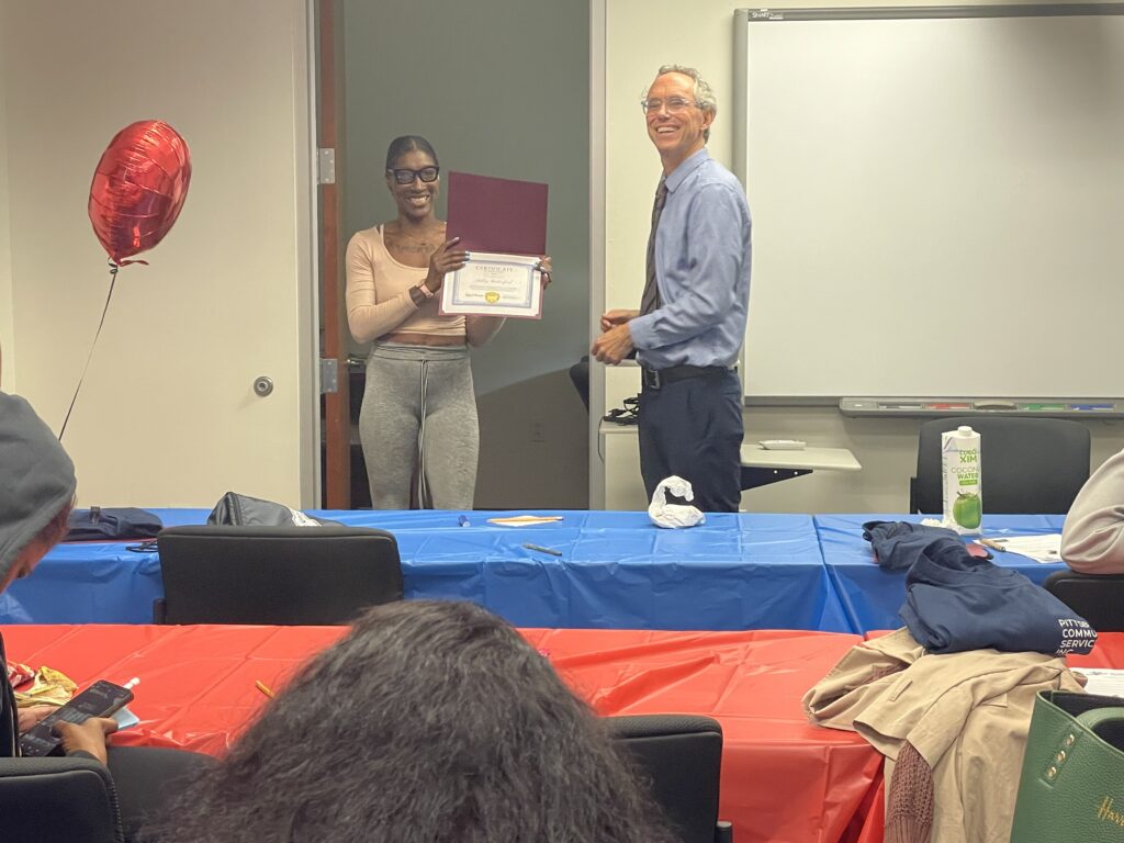 A Pr.E.P school graduate receiving a diploma