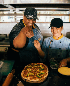 Food service workers making pizza
